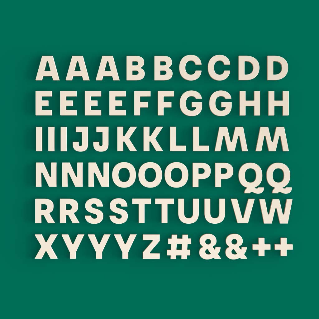 full set of 60 bone white wordbits alphabet magnet letters on green background