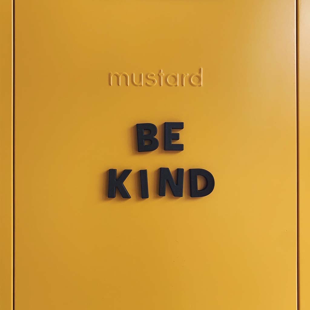 Mustard Made steel old school locker with black Wordbits magnet letters spelling "be kind" on it